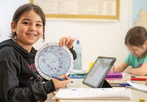 Amina (8) orientiert sich mit Hilfe einer Astro-Drehscheibe am Sternenhimmel